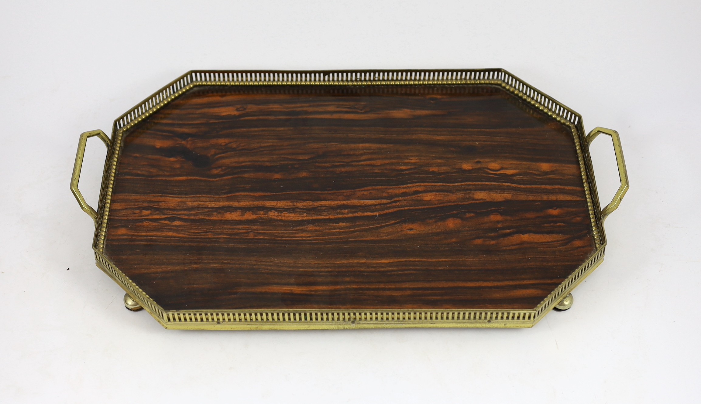 A Victorian brass mounted coromandel wood stationery casket with matching blotter, a similar book rack and gallery tray, 26cm